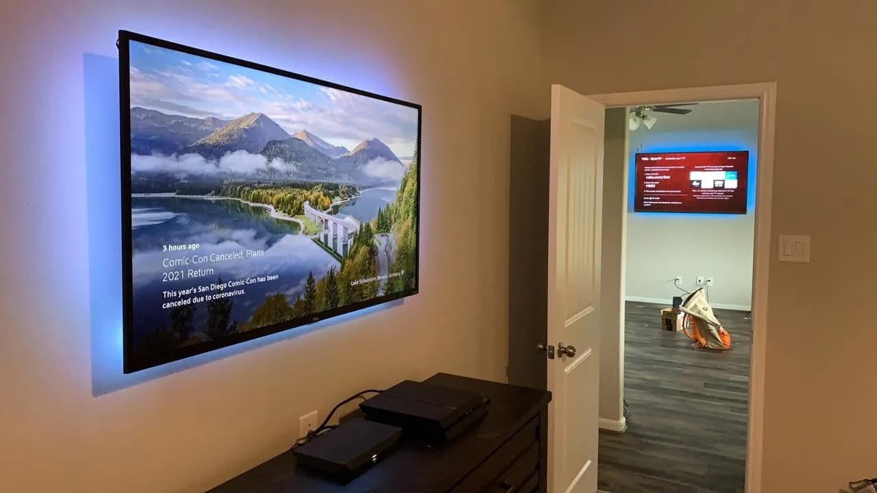 TV with blue LED backlight showing mountain landscape
