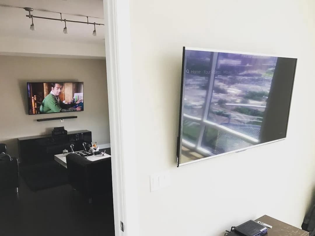 Dual TVs mounted in modern open loft